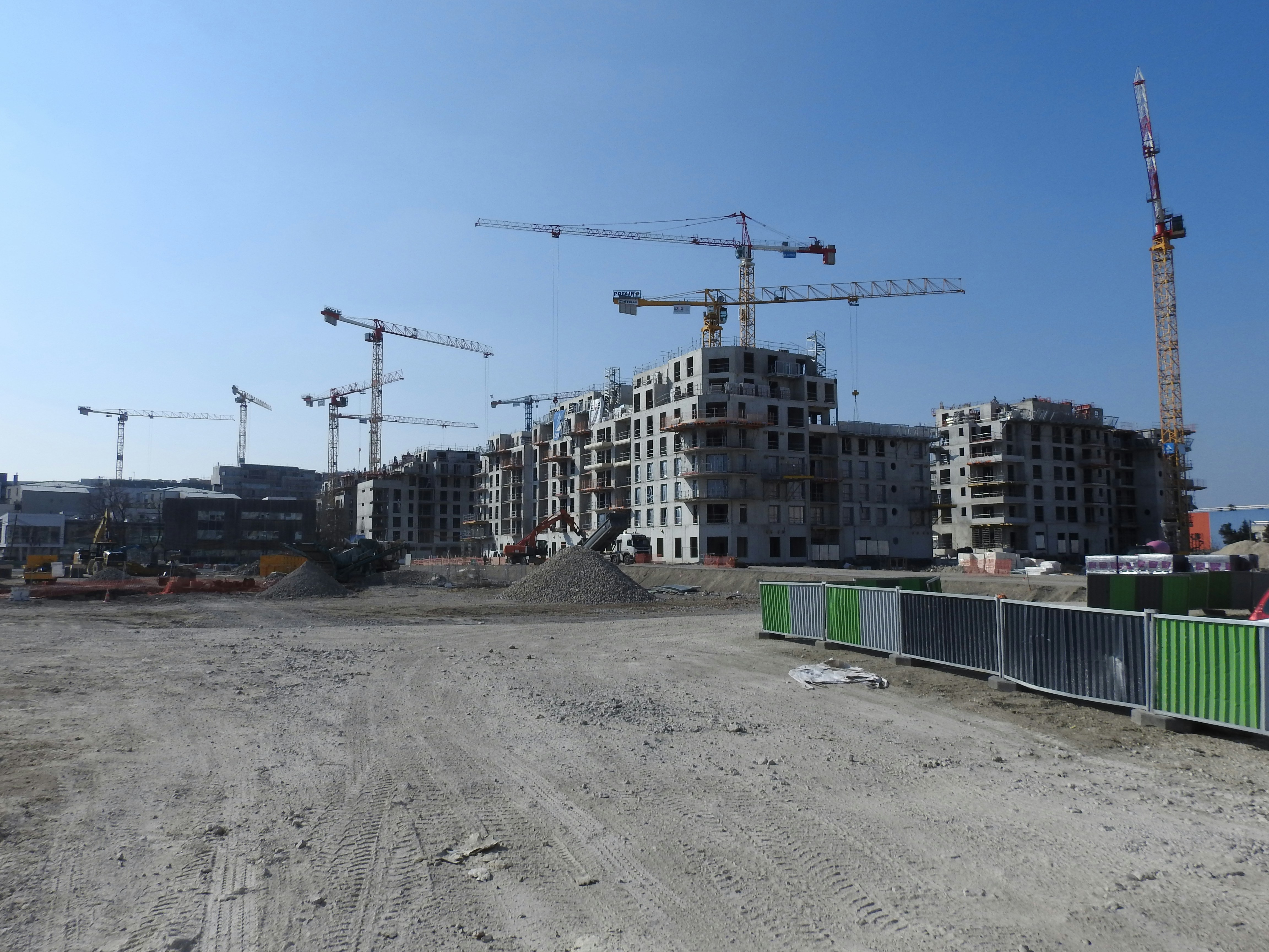 Tower crane over active foundation works at a construction site